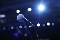 close-up-microphone-concert-hall-conference-room-with-cold-lights-background